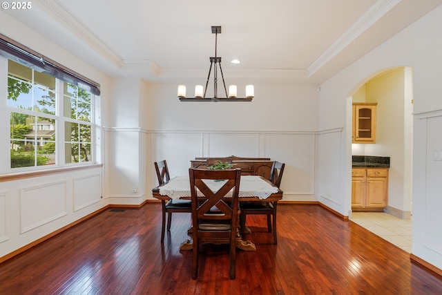 61 SW Wallingford Way, Beaverton, OR 97006 - dining area featuring a decorative wall, ornamental molding, hardwood / wood-style flooring, arched walkways, and a chandelier