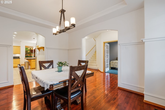 61 SW Wallingford Way, Beaverton, OR 97006 - dining space featuring arched walkways, light wood finished floors, ornamental molding, and a chandelier
