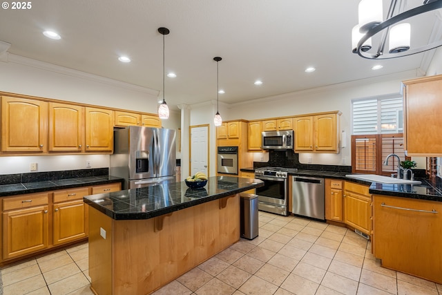 61 SW Wallingford Way, Beaverton, OR 97006 - kitchen with stainless steel appliances, tile counters, a sink, ornamental molding, and a center island