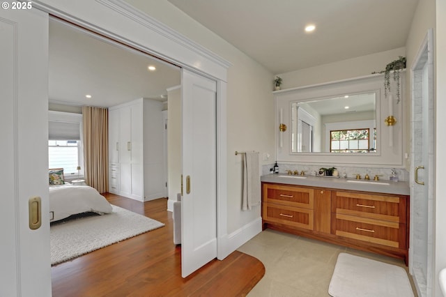 3701 NE Davis St, Portland, OR 97232 - ensuite bathroom featuring double vanity, healthy amount of natural light, recessed lighting, and wood finished floors