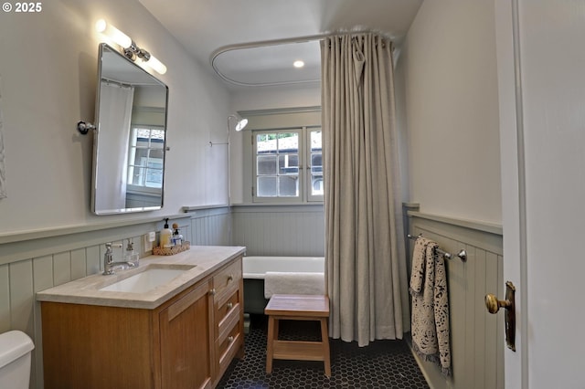 3701 NE Davis St, Portland, OR 97232 - full bath with vanity, a wainscoted wall, a decorative wall, and a tub