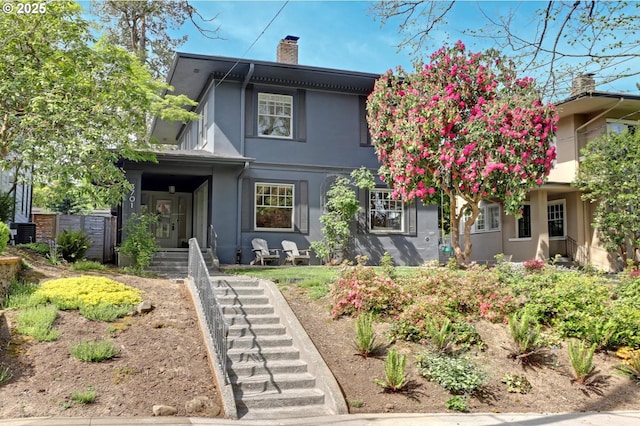 3701 NE Davis St, Portland, OR 97232 - view of front facade featuring stucco siding and a chimney