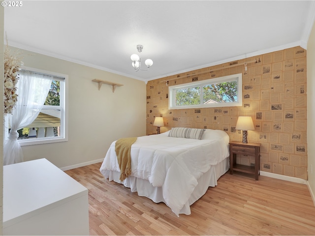 1466 8th St, Astoria, OR 97103 - bedroom featuring baseboards, ornamental molding, light wood-type flooring, and a chandelier