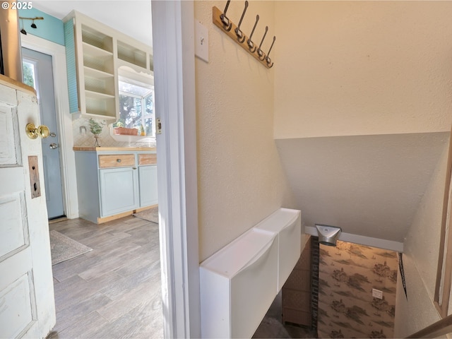 1466 8th St, Astoria, OR 97103 - bathroom featuring wood finished floors, plenty of natural light, and tasteful backsplash