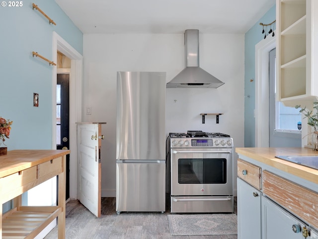 1466 8th St, Astoria, OR 97103 - kitchen with wall chimney exhaust hood, appliances with stainless steel finishes, and light countertops