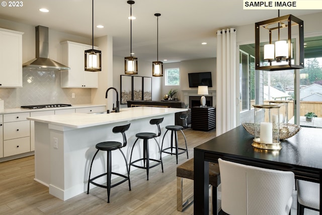 352 S 88th Ave, Ridgefield, WA 98642 - kitchen with wall chimney range hood, gas cooktop, tasteful backsplash, light wood-style flooring, and recessed lighting