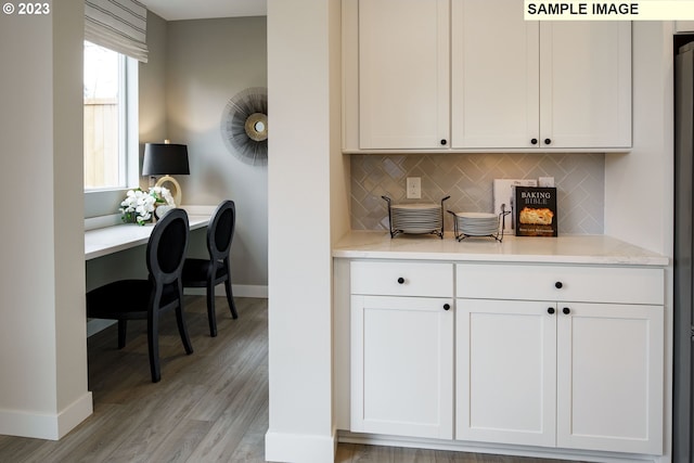 352 S 88th Ave, Ridgefield, WA 98642 - kitchen featuring light countertops, light wood finished floors, tasteful backsplash, and white cabinets
