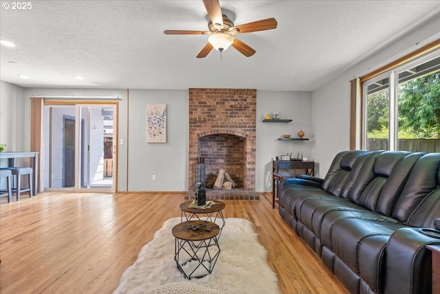 2130 SW 195th Ave, Beaverton, OR 97003 - living area featuring ceiling fan, a textured ceiling, wood finished floors, a brick fireplace, and recessed lighting