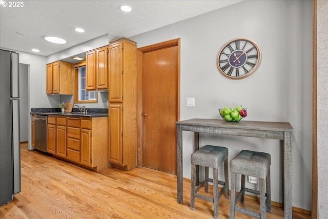 2130 SW 195th Ave, Beaverton, OR 97003 - kitchen with dishwasher, freestanding refrigerator, dark countertops, light wood-type flooring, and recessed lighting