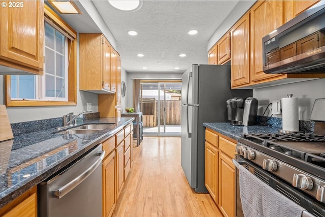 2130 SW 195th Ave, Beaverton, OR 97003 - kitchen with stainless steel appliances, light wood-style flooring, dark stone counters, recessed lighting, and a textured ceiling