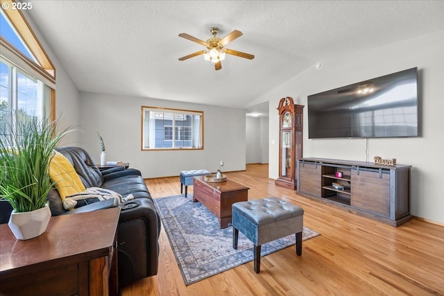 2130 SW 195th Ave, Beaverton, OR 97003 - living area with lofted ceiling, ceiling fan, a textured ceiling, and light wood-style flooring