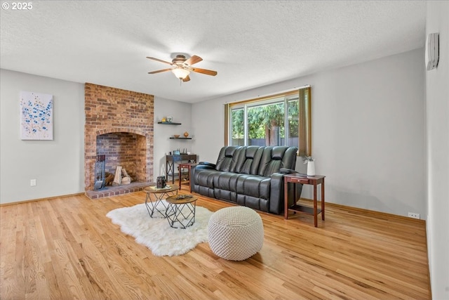 2130 SW 195th Ave, Beaverton, OR 97003 - living area featuring ceiling fan, wood finished floors, a textured ceiling, and a fireplace