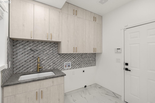 laundry room featuring electric dryer hookup, light tile floors, cabinets, hookup for a washing machine, and sink