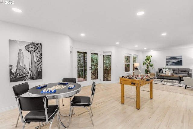 dining space featuring french doors and light wood-type flooring