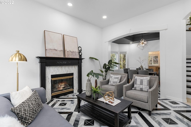 living room featuring a high end fireplace