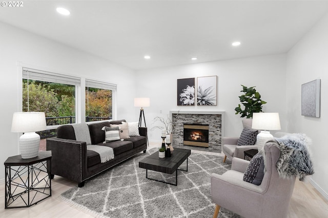 living room with light hardwood / wood-style flooring and a fireplace