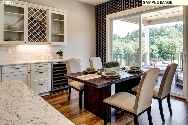 interior space featuring dark wood-type flooring, indoor bar, and wine cooler