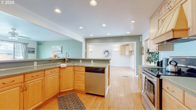 kitchen with custom exhaust hood, recessed lighting, a sink, stainless steel appliances, and light wood-style floors