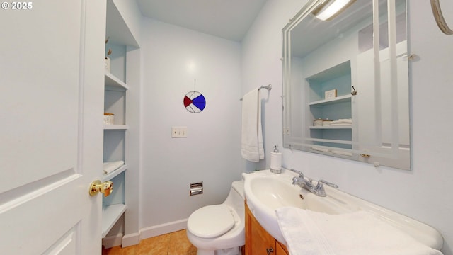 bathroom with tile patterned floors, baseboards, toilet, and vanity