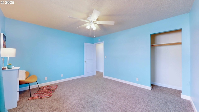 unfurnished bedroom featuring a textured ceiling, baseboards, and carpet floors