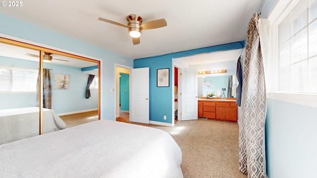 bedroom with a ceiling fan, baseboards, a closet, and connected bathroom