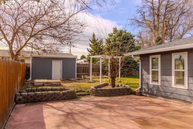 view of patio / terrace with a storage shed, an outdoor structure, and a fenced backyard