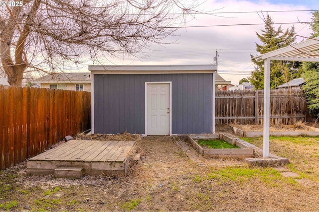 view of shed with a garden and a fenced backyard