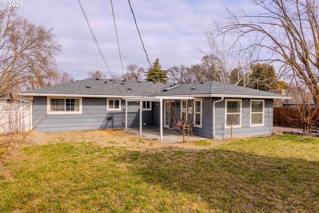 back of house featuring a patio, fence, a pergola, a shingled roof, and a lawn