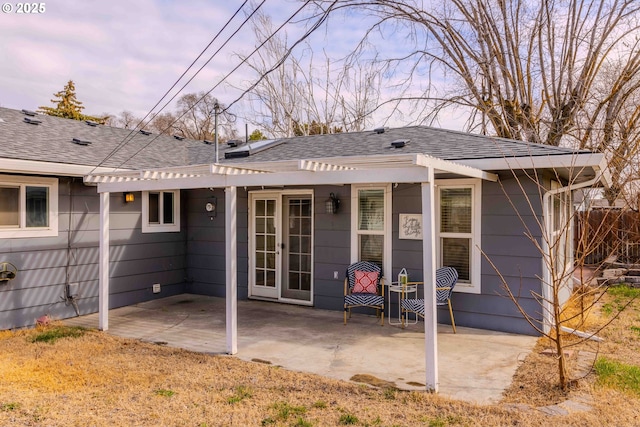 rear view of house with fence, roof with shingles, a pergola, french doors, and a patio area