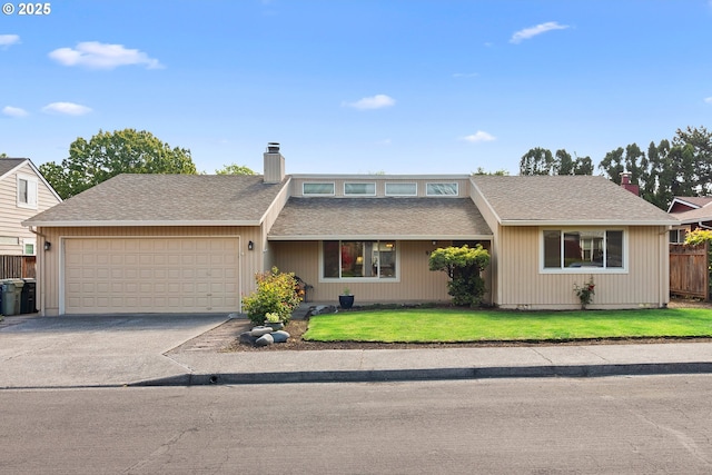 mid-century home with a chimney, an attached garage, driveway, and roof with shingles