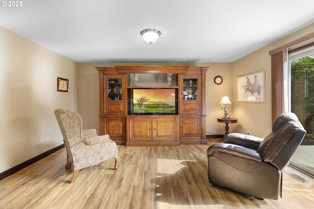 living room featuring light wood-style flooring and baseboards