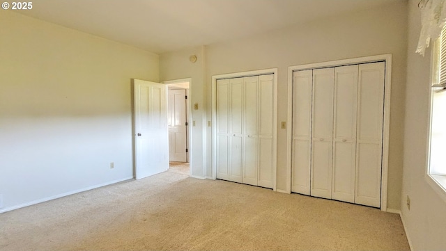 36582 Valley View Ln, Halfway, OR 97834 - unfurnished bedroom with baseboards, multiple closets, and light carpet