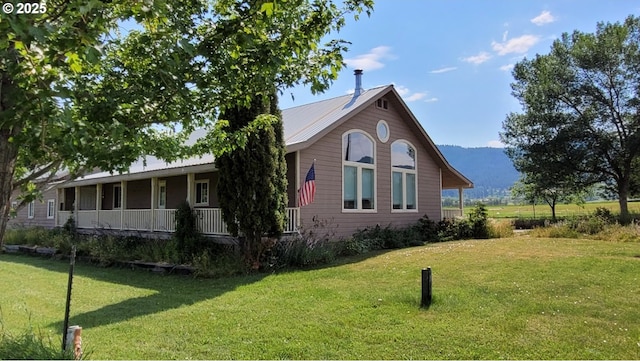 36582 Valley View Ln, Halfway, OR 97834 - view of property exterior with a mountain view, a yard, and covered porch