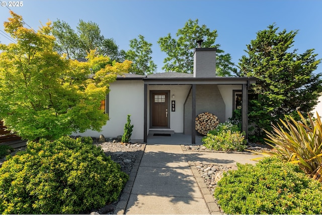 512 NE Division St, Myrtle Creek, OR 97457 - view of front facade featuring stucco siding and a chimney