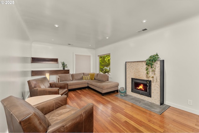 512 NE Division St, Myrtle Creek, OR 97457 - living room featuring light wood finished floors, a fireplace with flush hearth, and recessed lighting