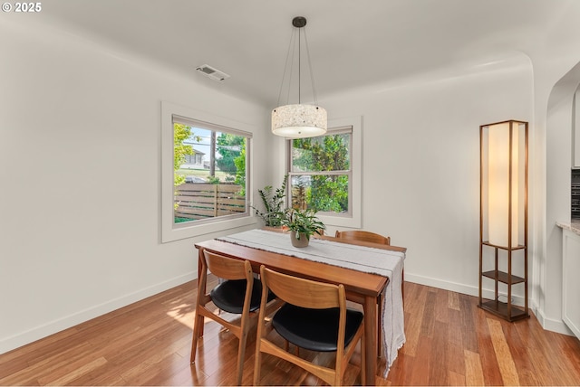 512 NE Division St, Myrtle Creek, OR 97457 - dining area with light wood-style flooring, arched walkways, and baseboards