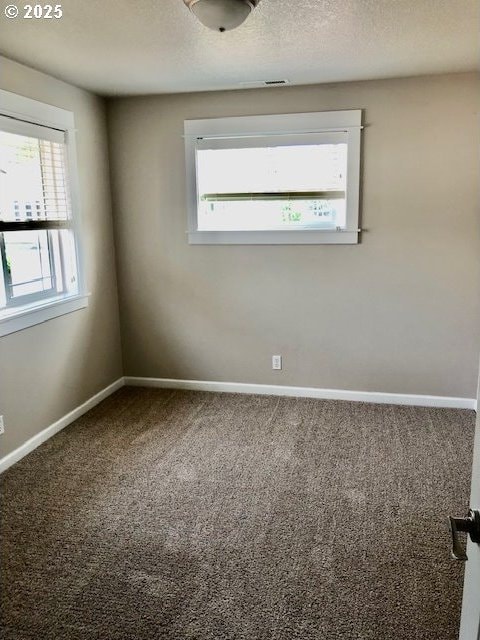 3843 Shannon St, Eugene, OR 97404 - empty room featuring carpet and a textured ceiling