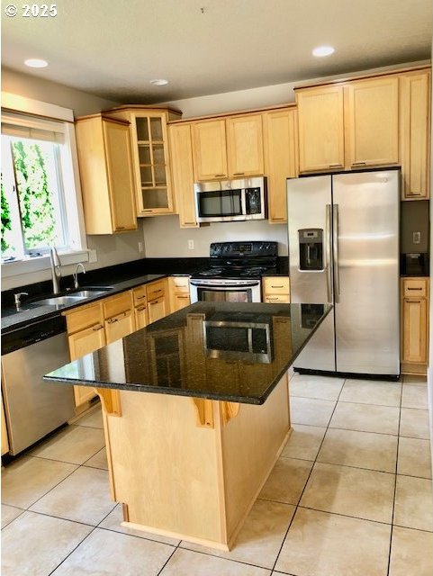 3843 Shannon St, Eugene, OR 97404 - kitchen featuring stainless steel appliances, a kitchen island, light brown cabinetry, glass insert cabinets, and recessed lighting