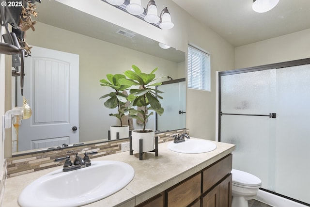 52193 SE Tussing Way, Scappoose, OR 97056 - full bathroom with toilet, a shower stall, double vanity, and tasteful backsplash