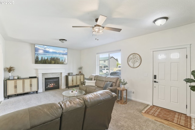 52193 SE Tussing Way, Scappoose, OR 97056 - living area featuring light carpet, ceiling fan, a tile fireplace, and baseboards