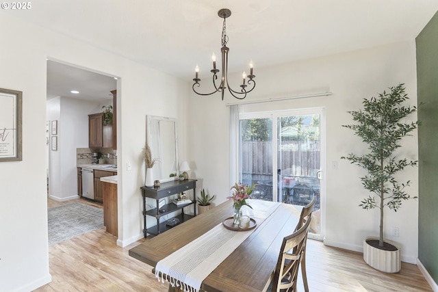 52193 SE Tussing Way, Scappoose, OR 97056 - dining space with a chandelier, light wood-type flooring, and baseboards