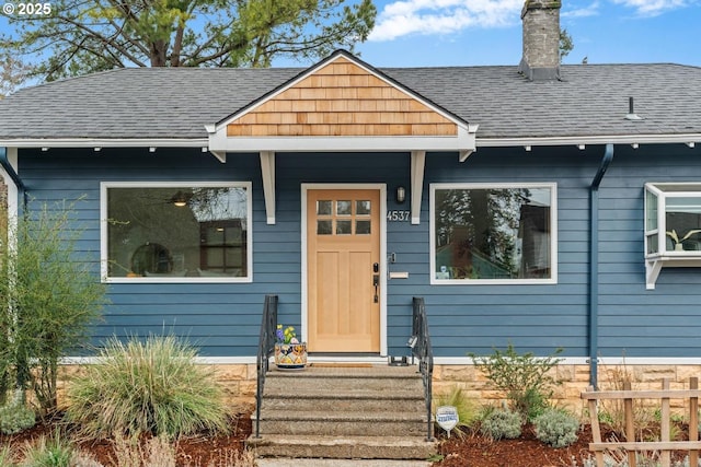 view of front of house with a shingled roof