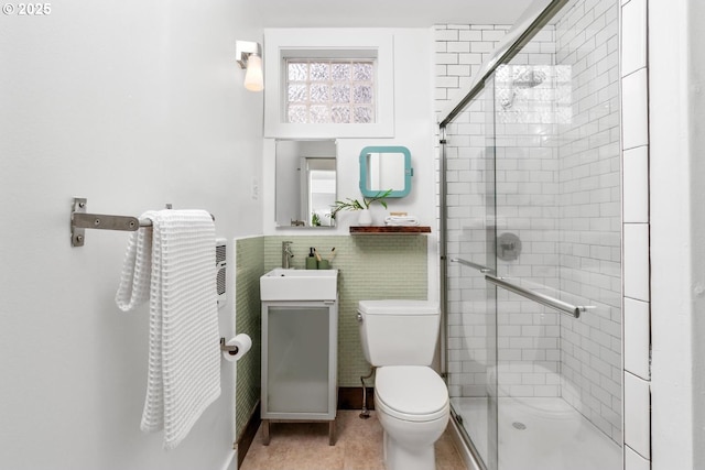 bathroom with vanity, a shower stall, and toilet