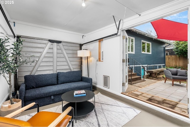 living area featuring stairs and concrete floors