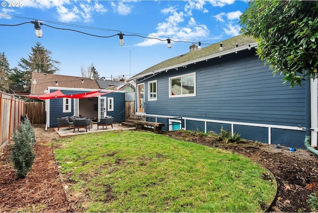 rear view of house featuring a patio area, a lawn, entry steps, and a fenced backyard