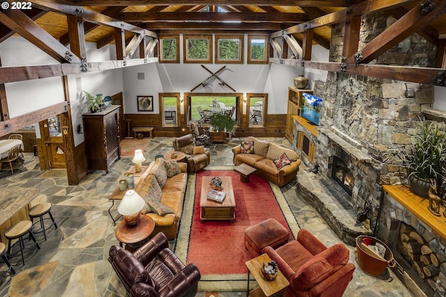 living room with lofted ceiling with beams and a fireplace