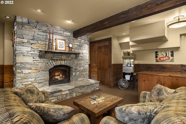 carpeted living room featuring a fireplace and beam ceiling