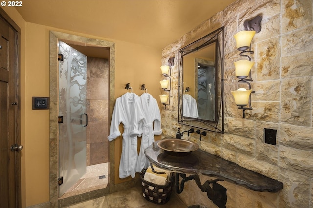 bathroom featuring vanity, a shower with door, and tile floors