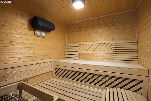 view of sauna with wood walls and wood ceiling