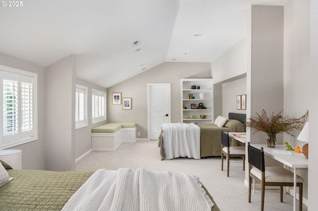 bedroom with vaulted ceiling, light colored carpet, and baseboards